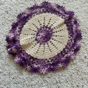 Purple doiley, made by hand.